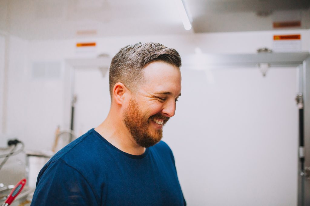 justin bland in his food truck smiling